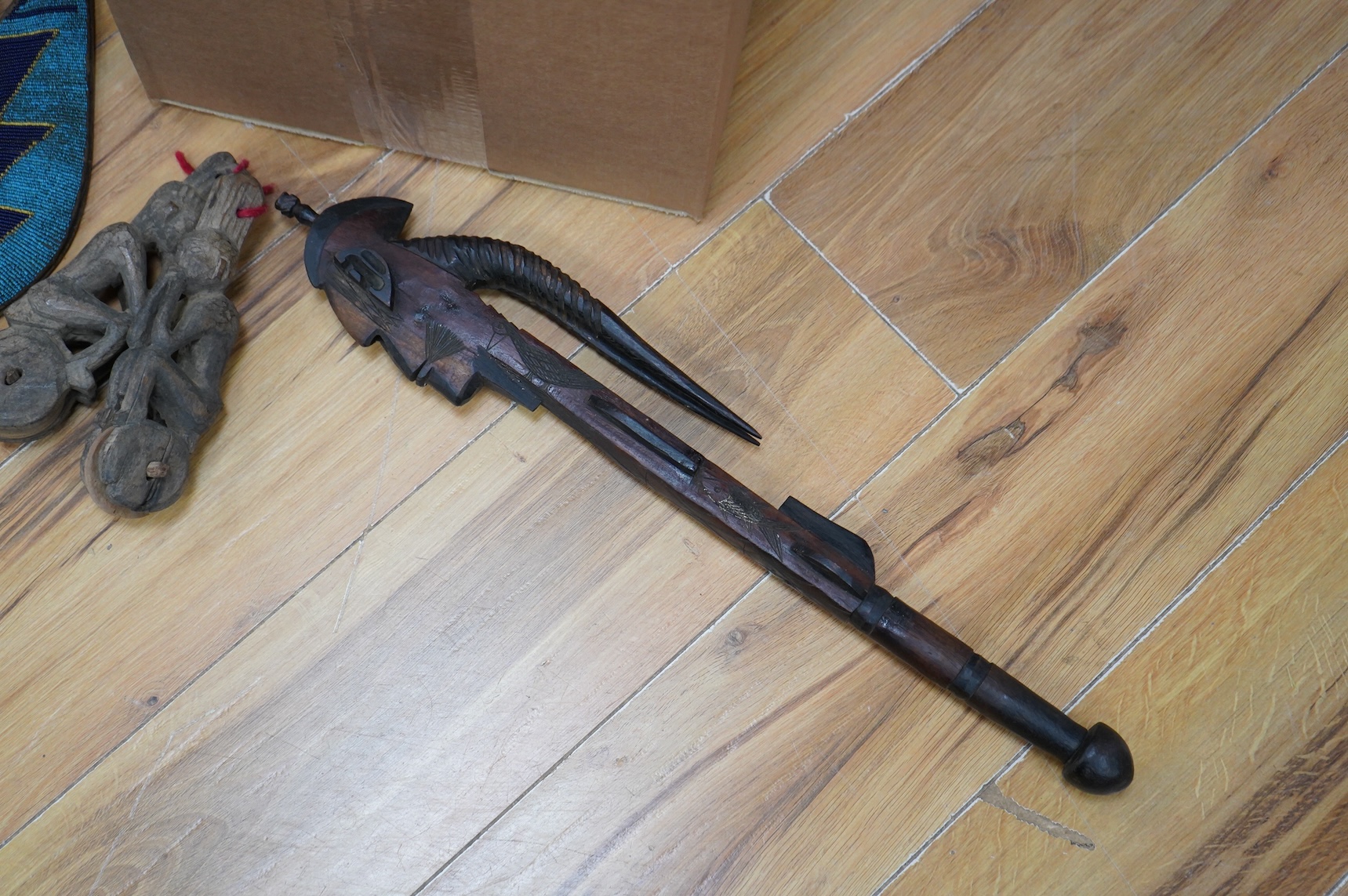 A collection of Burmese items to include wood weaving block, two figural weaving pulleys, two arrow heads and two trunk pots
